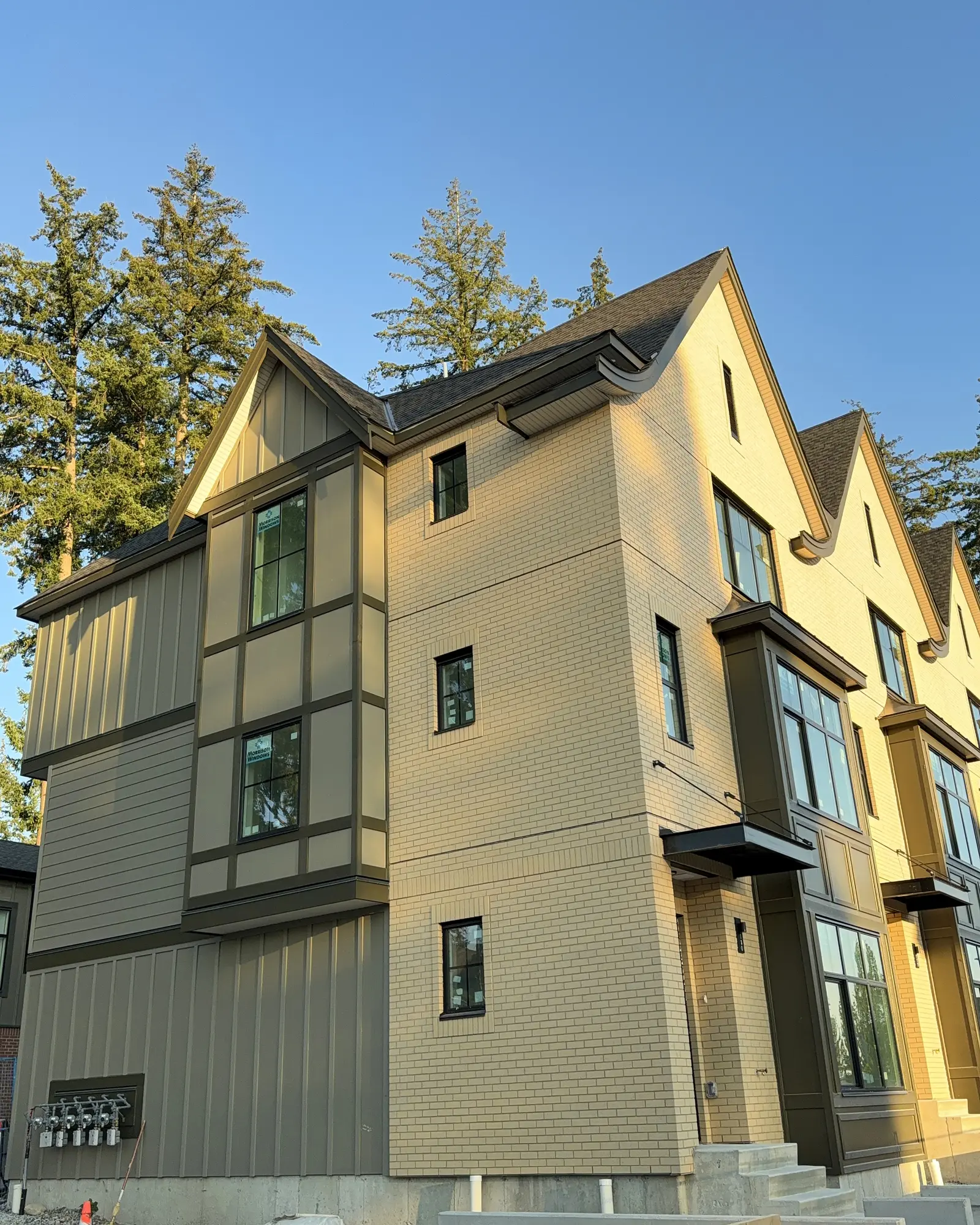 Gabled townhouse exteriors with brick and panel cladding by Moonrise Construction, Fraser Valley BC
