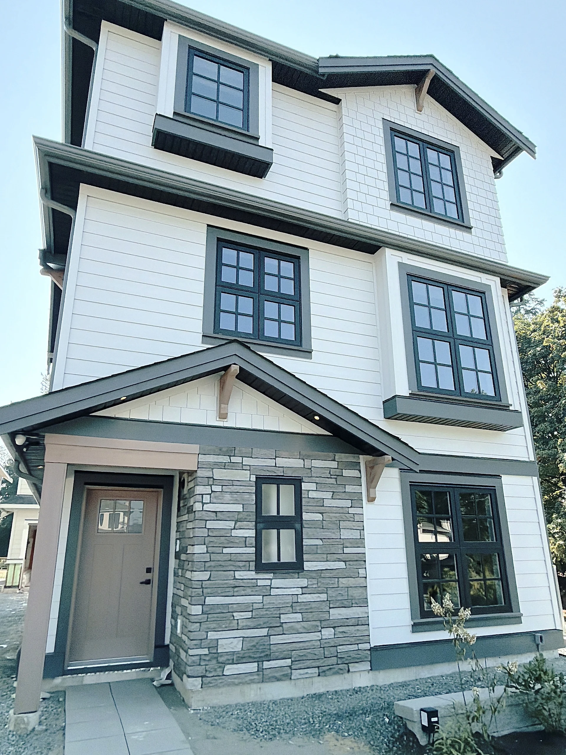Full-height elevation in white Hardie lap and shake with black trim, Burnaby BC