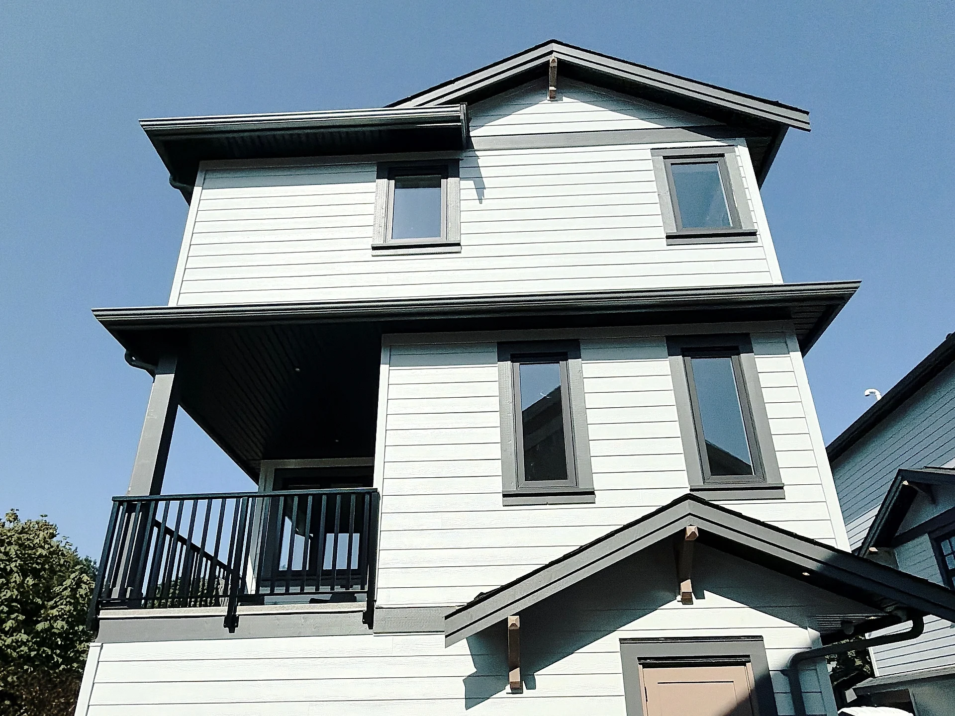 Rear corner in white lap siding with black trim, Burnaby BC
