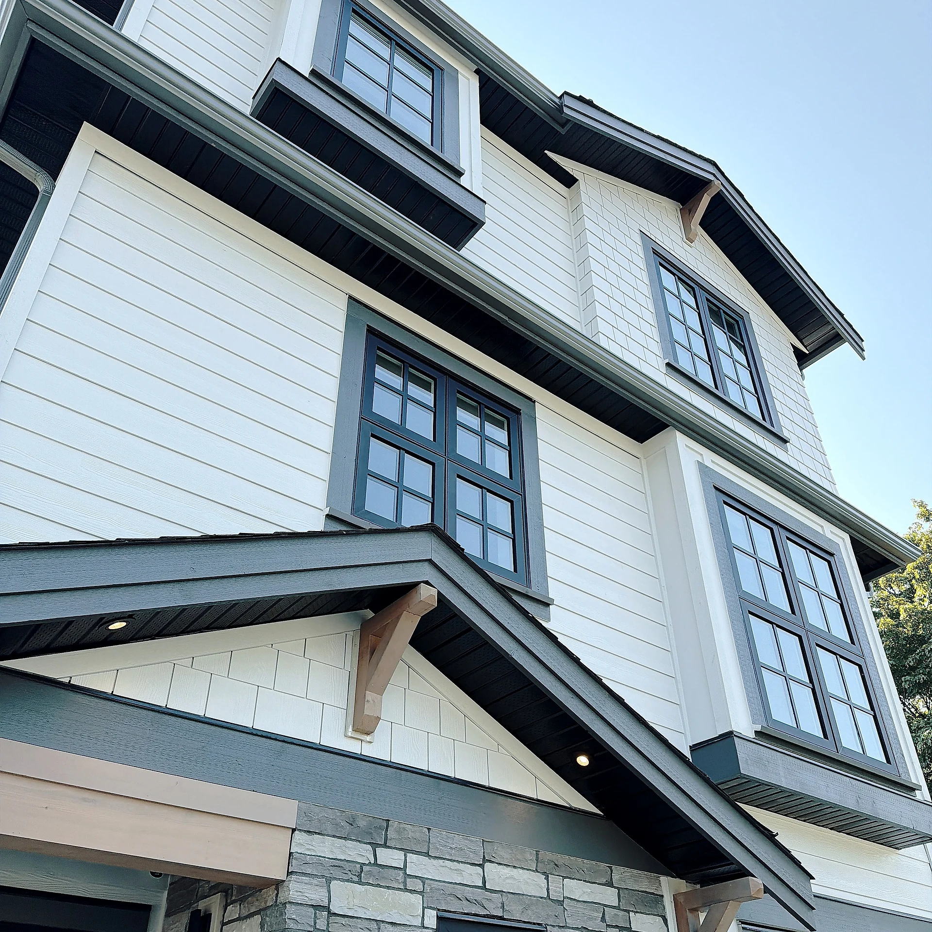 Shake gable with timber brackets over white lap siding, Burnaby BC