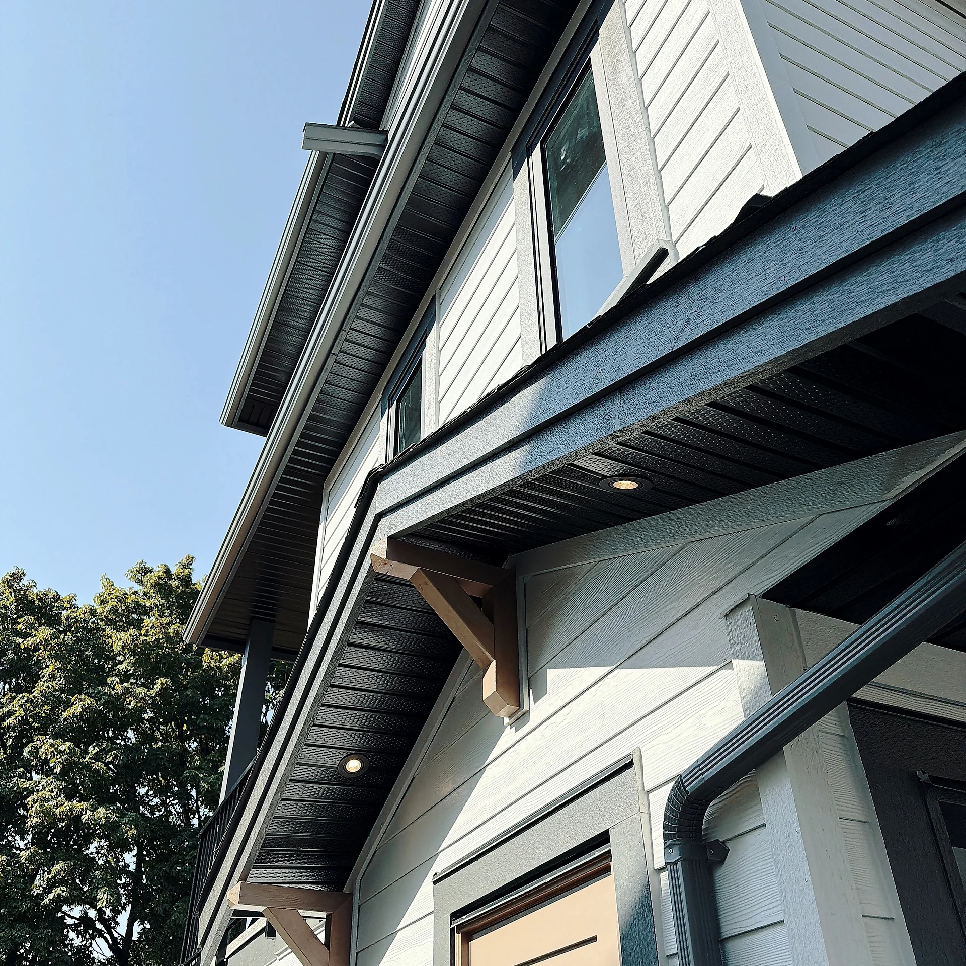 Eave and trim detail on white lap siding, Burnaby BC