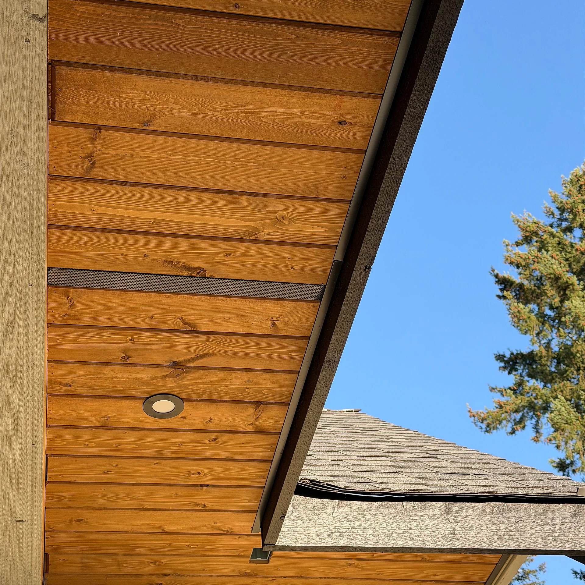 Vented cedar eave soffit with continuous vent strip and pot light, Langley BC