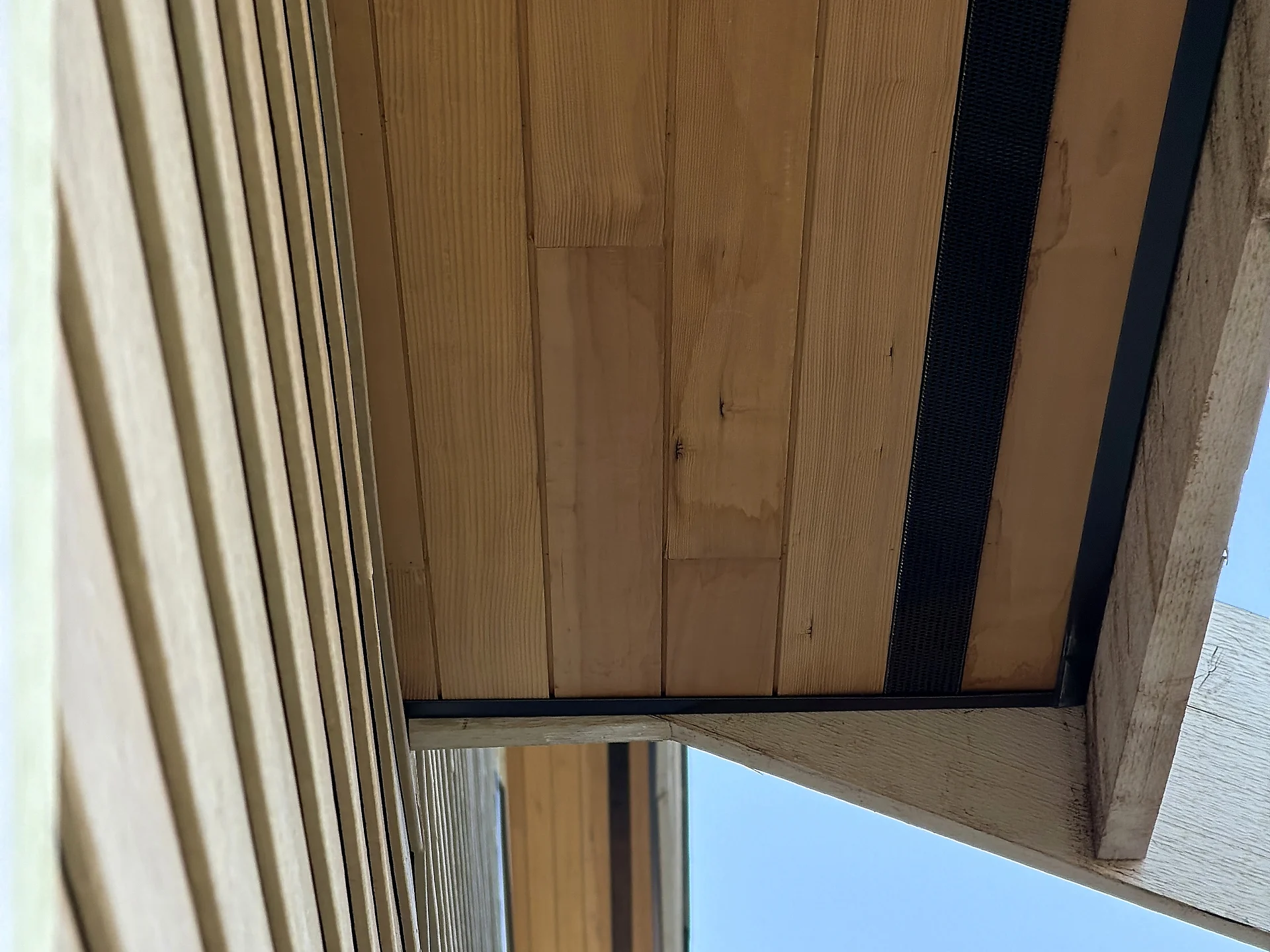 Cedar soffit along the roofline with the sky behind, North Vancouver BC