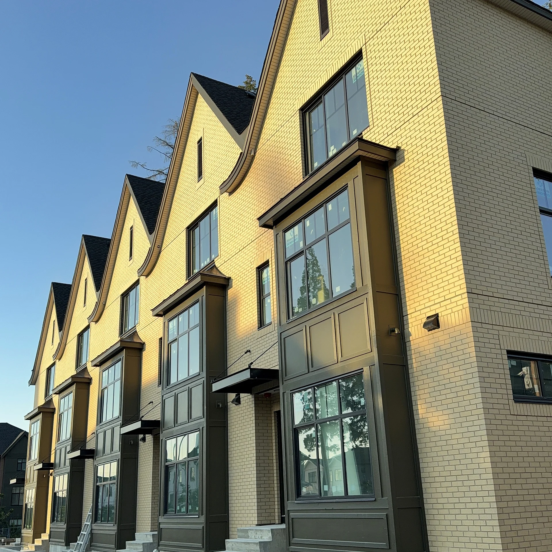Dark panel bay stack against tan brick, detail, South Surrey BC
