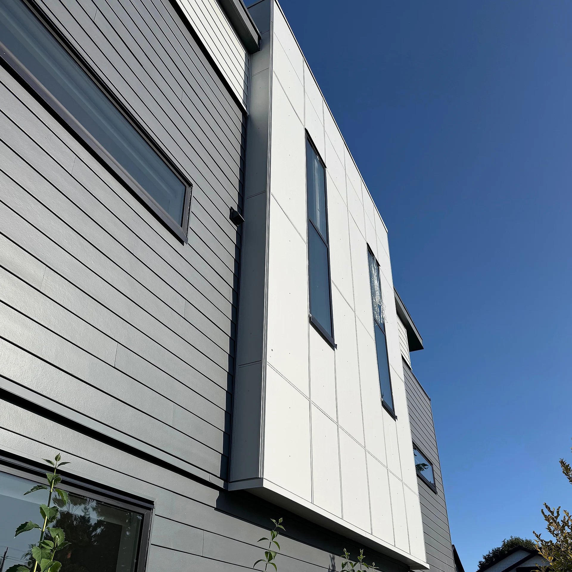 White panel corner meeting grey lap siding, detail, South Surrey BC