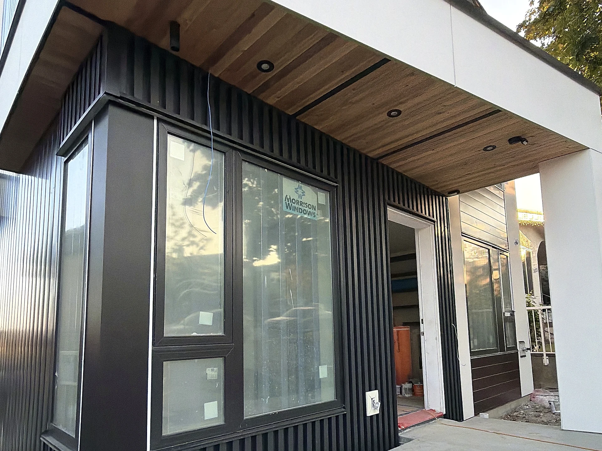 Black vertical-cladding bay with glazing, Vancouver BC