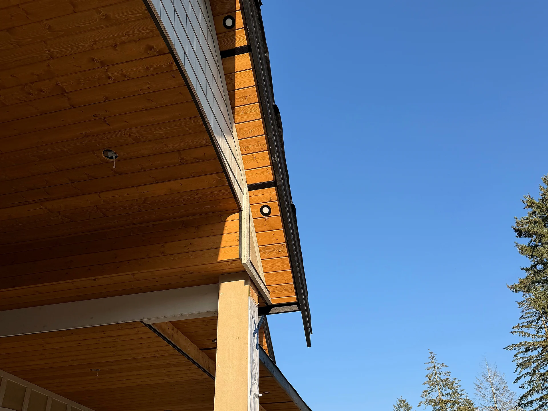 Cedar tongue-and-groove porch soffit and column on a Langley, BC custom home by Moonrise Construction